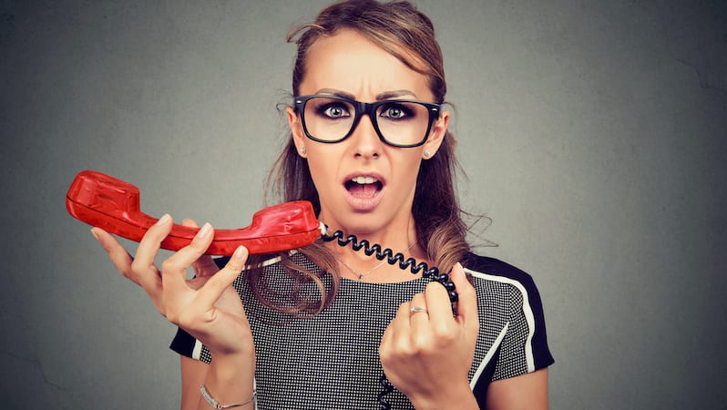 Shocked woman receiving bad news on the phone