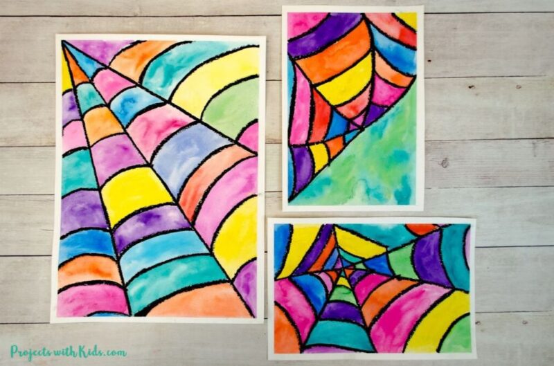 Fall art projects can include watercolor projects like this one.  Three pieces of paper are divided into a web with black and each section of the web is colored in a different color using watercolor paints.