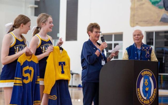 School students and alumni speak at a school pep rally (Spirit Week Ideas)