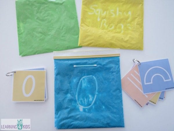 Resealable plastic bags filled with colorful slime for kids to use for writing practice