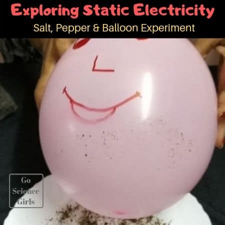 A pink balloon has a face drawn on it. It is hovering over a plate with salt and pepper on it (easy science experiments)