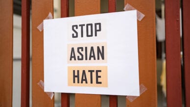 Stop Asian Hate sign attached on the house fence