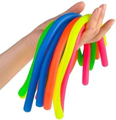 A hand is holding long skinny stretchy tubes in various colors (sensory toys)