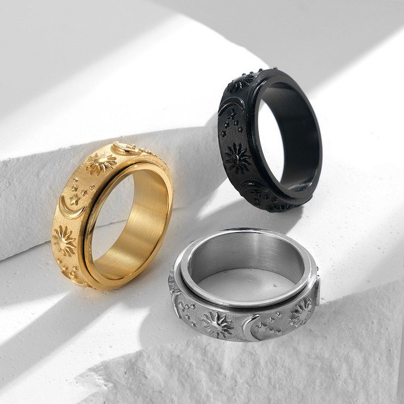 Gold, silver, and black spinning fidget rings with sun, moon, and stars patterns