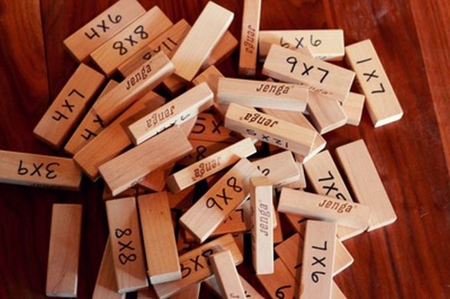 Jengo wooden blocks with multiplication facts written on them
