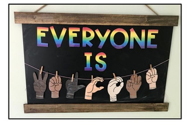 Rainbow colored letters saying Everyone Is with hands in a variety of colors spelling out the ASL letters for Welcome