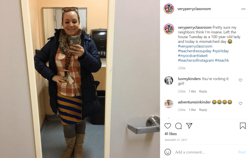 Teacher taking a picture in font of a mirror while wearing mismatched clothes to celebrate mismatch day