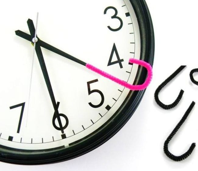 Analog clock with a pink pipe cleaner hook attached to the hour hand (Telling Time)