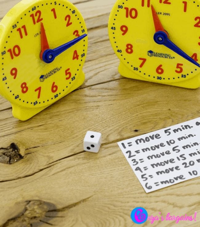 Two toy clocks and a notecard with the rules for the Rush Hour game (Telling Time)