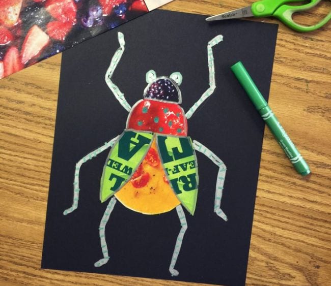 Winged bug made of magazine scraps with chalk legs on black paper