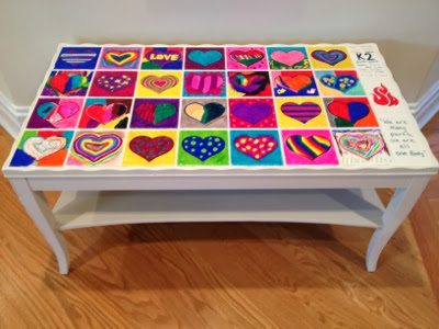 art auction ideas- a coffee table with colorful hear painted tiles on top made by students 
