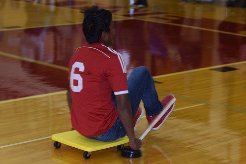 Student rolling on floor