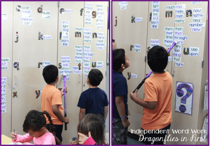students stand at a word wall pointing to words with a stick