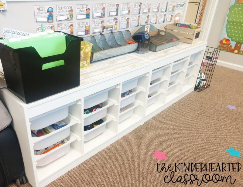 Two white shelving units are shown with 9 tubs in each unit are shown in a classroom setting, as an example of IKEA classroom supplies.