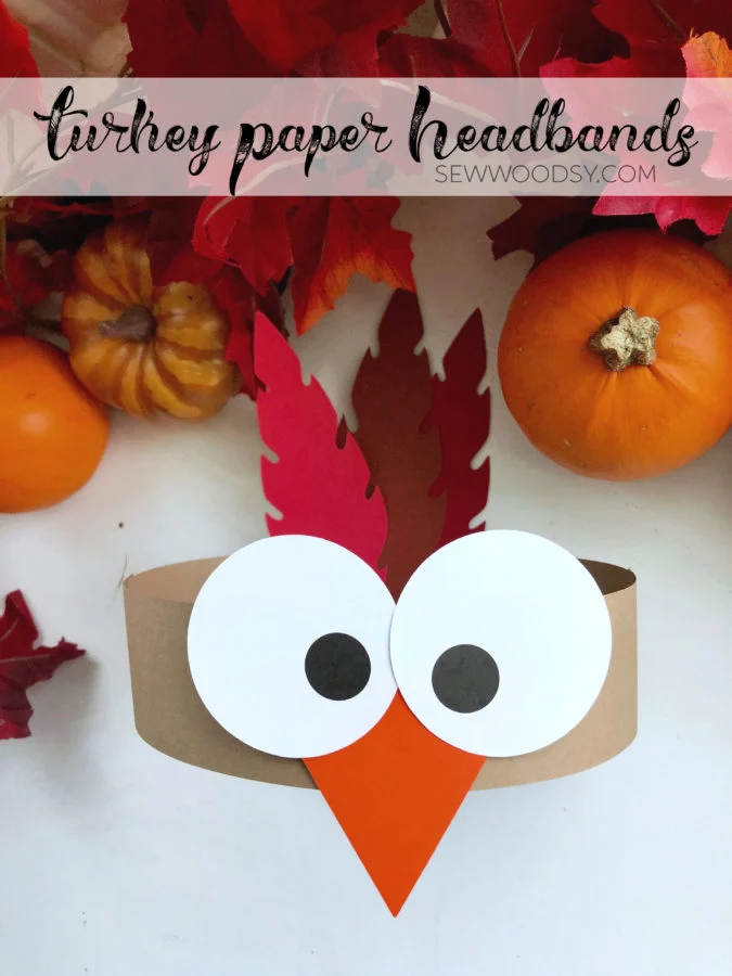 A headband is made from cardstock. It has two googly eyes and a beak and two feathers in the back. This is an example of fall art projects.