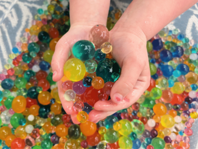 Hands holding water beads