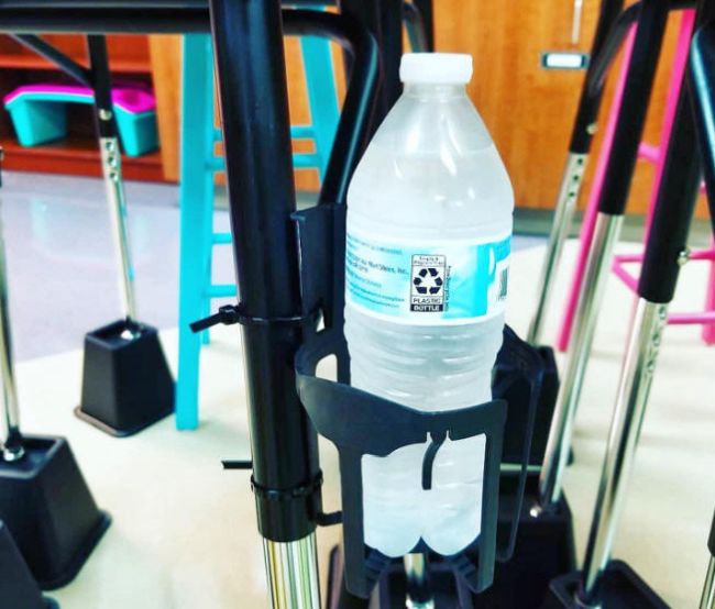 Car window drink holder repurposed as a water bottle holder for student desks by using zip ties