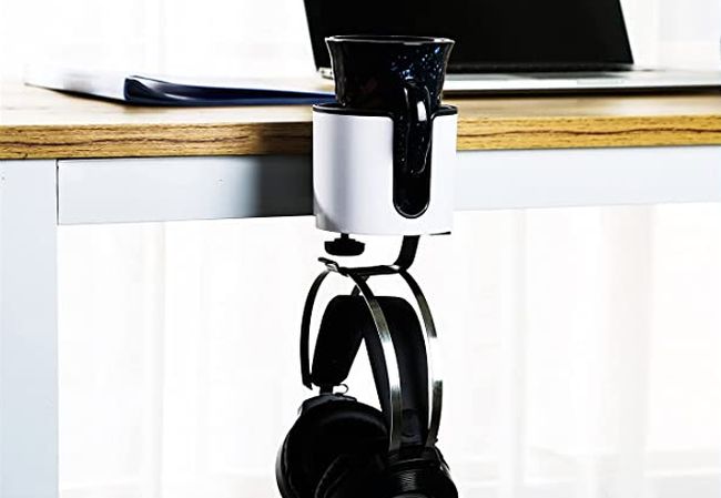 Cup holder with hook for holding headphones attached to a desk