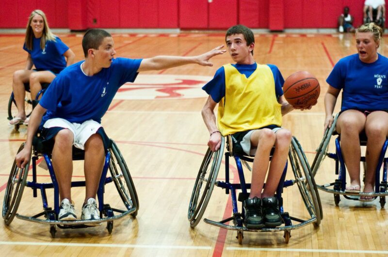 young people playing a game of wheelchair basketball