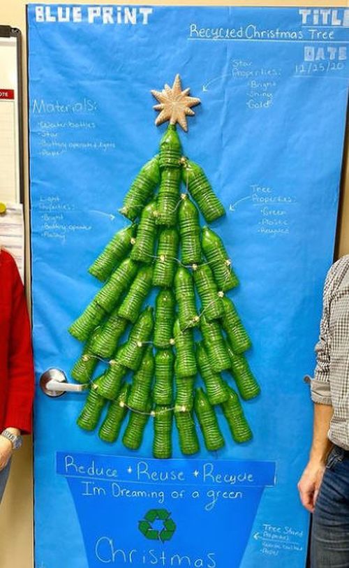 Door decorated with a Christmas tree made of empty plastic bottles painted green