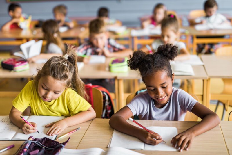 Young students writing in class